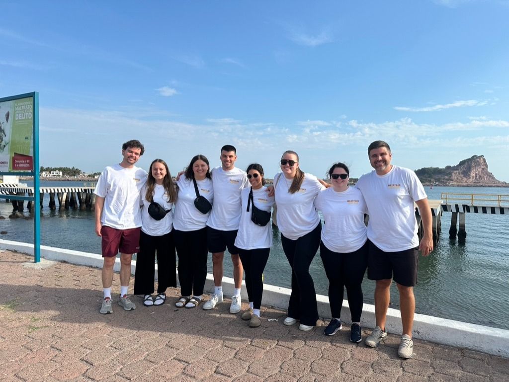 A Three Creeks team in matching trip shirts on the waterfront in Mazatlán, Mexico.