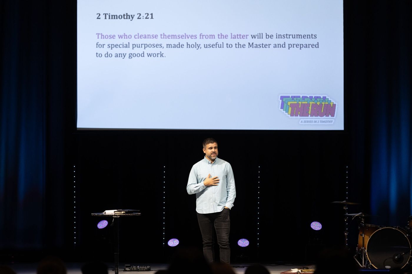 A pastor teaching from the stage during a Sunday service.